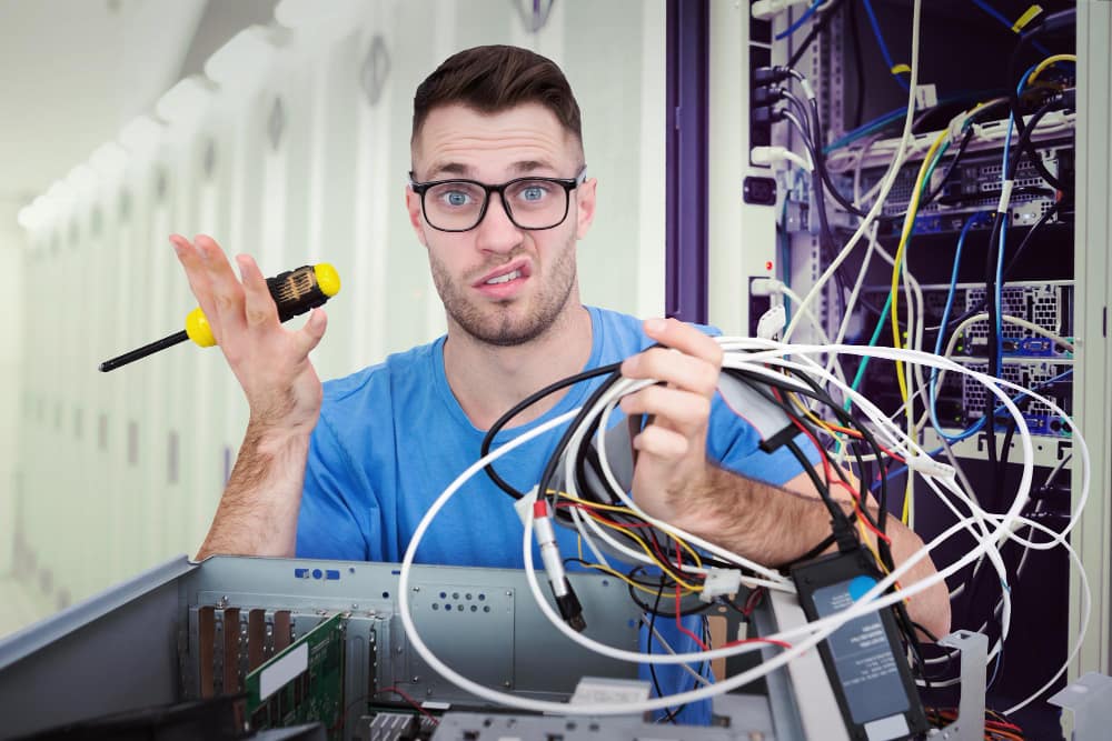 composite-image-portrait-confused-it-professional-with-screw-driver-cables-front-ope structured cabling
